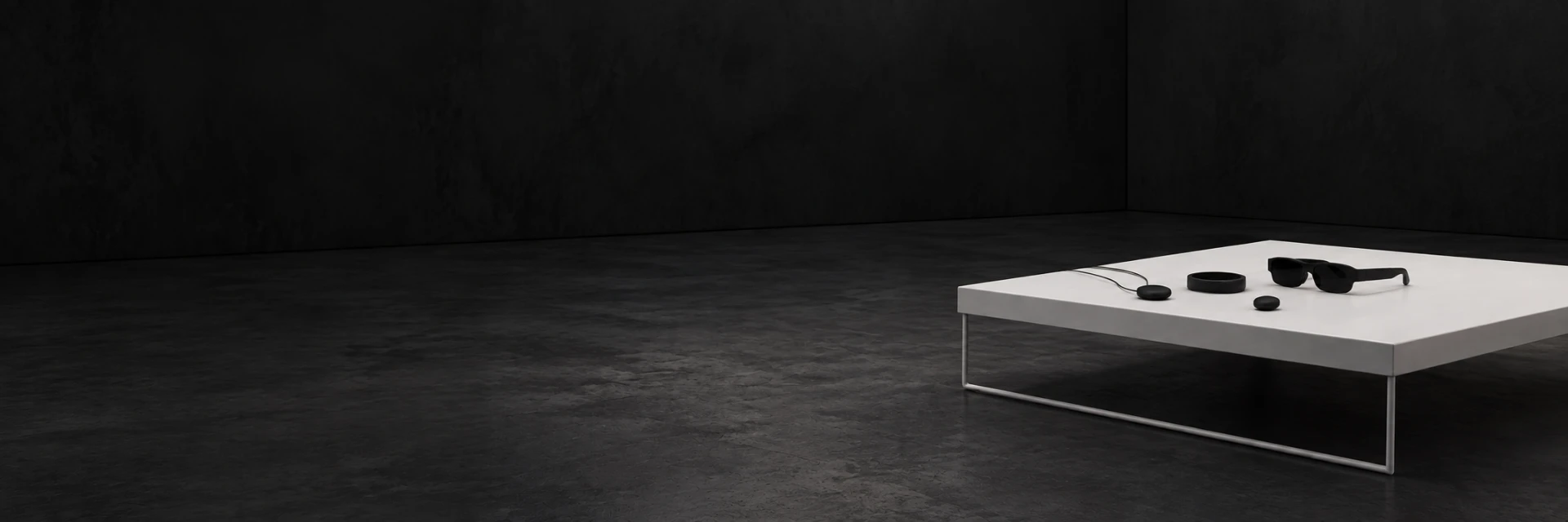 Vanta wearables on a white table in a dark studio
